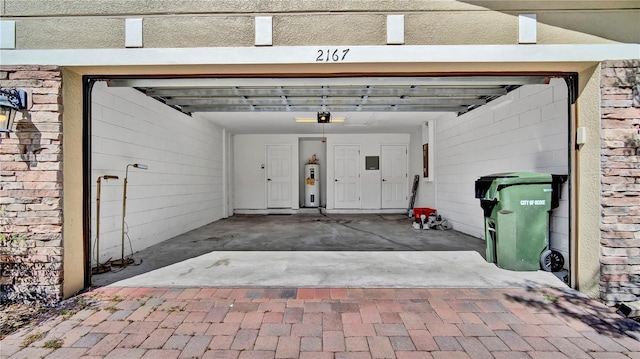 2167 Velvet Leaf Dr, Ocoee, FL 34761 - garage featuring electric water heater, a garage door opener, and driveway