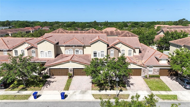 2167 Velvet Leaf Dr, Ocoee, FL 34761 - mediterranean / spanish-style house with driveway, stucco siding, a residential view, and a tile roof