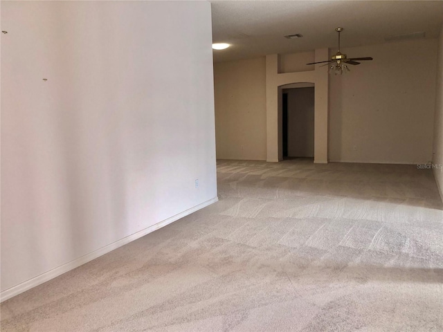 1805 San Luis Ln, The Villages, FL 32159 - spare room featuring arched walkways, light colored carpet, and a ceiling fan