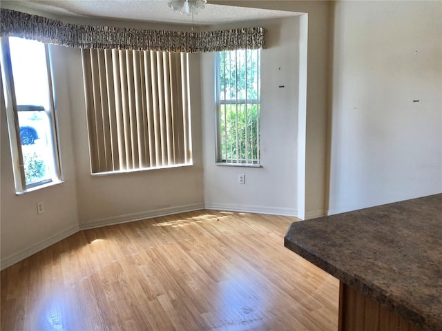 1805 San Luis Ln, The Villages, FL 32159 - dining area featuring healthy amount of natural light, light wood finished floors, and baseboards