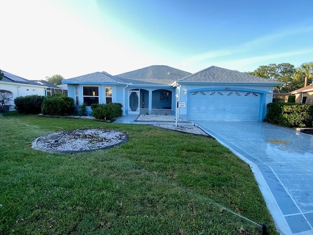 1805 San Luis Ln, The Villages, FL 32159 - ranch-style house with a garage, decorative driveway, a front yard, and stucco siding