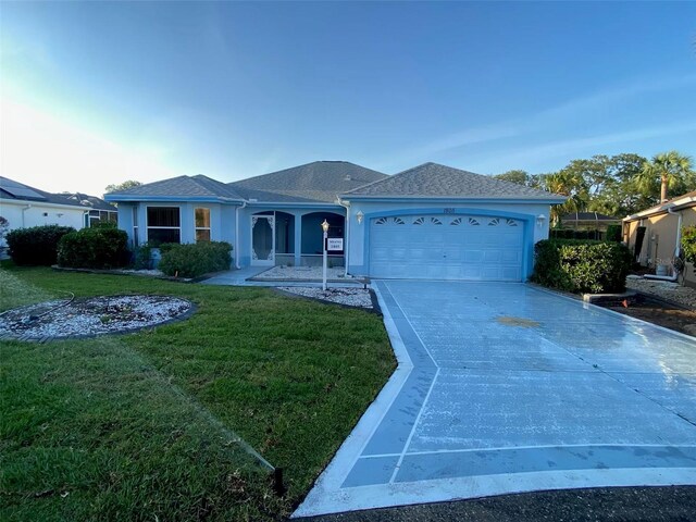 1805 San Luis Ln, The Villages, FL 32159 - single story home with concrete driveway, a garage, a front lawn, and stucco siding
