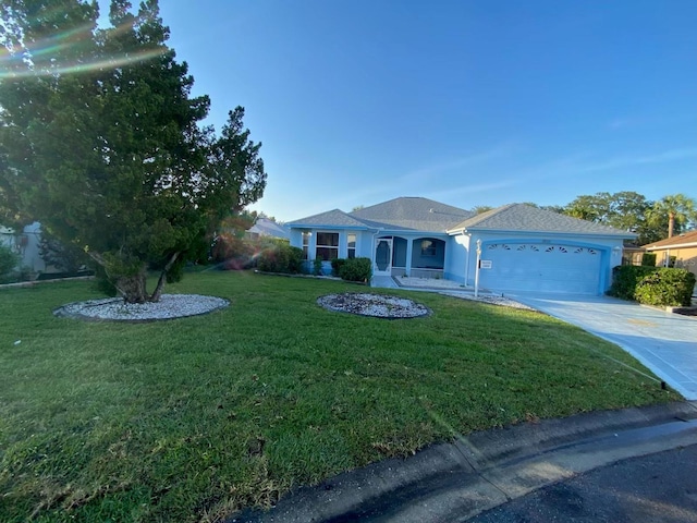 1805 San Luis Ln, The Villages, FL 32159 - ranch-style house with a garage, driveway, and a front lawn