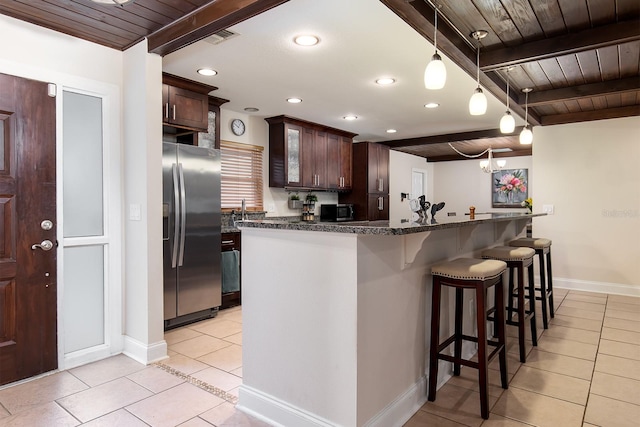 kitchen with recessed lighting, light tile patterned floors, beam ceiling, and appliances with stainless steel finishes