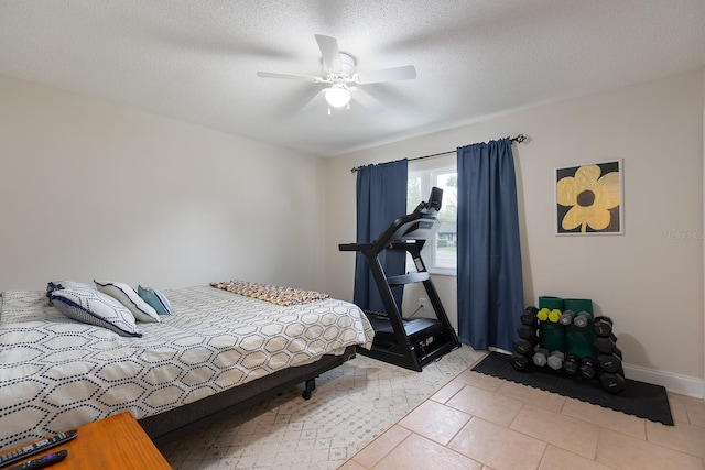 bedroom featuring light tile patterned floors, baseboards, a textured ceiling, and ceiling fan