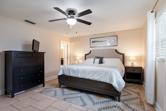 bedroom featuring visible vents, baseboards, light tile patterned flooring, and ceiling fan