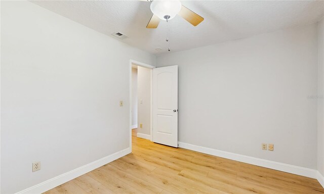 7845 Clubhouse Estates Dr, Orlando, FL 32819 - spare room featuring light wood-style floors, visible vents, a ceiling fan, and baseboards