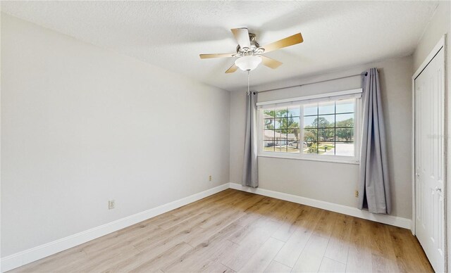 7845 Clubhouse Estates Dr, Orlando, FL 32819 - empty room with light wood-style flooring, baseboards, a textured ceiling, and a ceiling fan