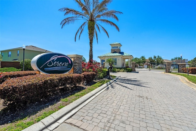 1918 Marabou Dr, Davenport, FL 33896 - view of road with a gate, a gated entry, curbs, and street lights