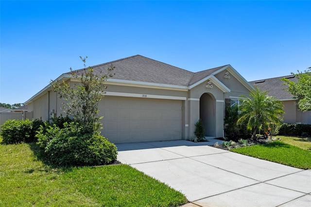 1918 Marabou Dr, Davenport, FL 33896 - ranch-style house featuring a front lawn, driveway, a garage, a shingled roof, and stucco siding