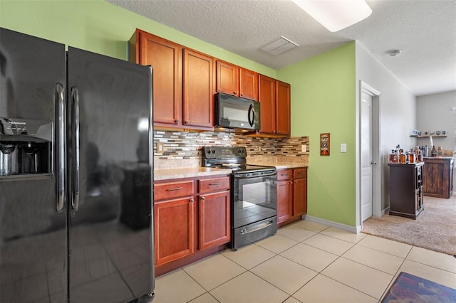1918 Marabou Dr, Davenport, FL 33896 - kitchen with a textured ceiling, visible vents, backsplash, light countertops, and black appliances