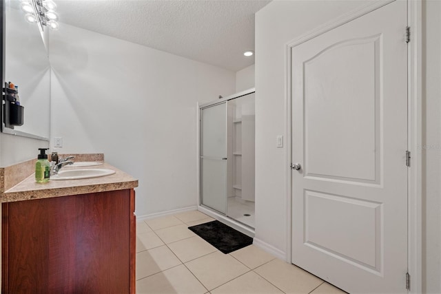 1918 Marabou Dr, Davenport, FL 33896 - full bath featuring tile patterned flooring, vanity, baseboards, a textured ceiling, and a stall shower