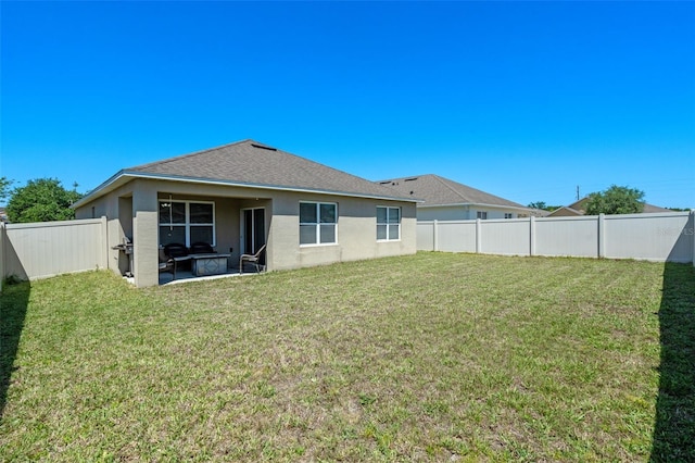 1918 Marabou Dr, Davenport, FL 33896 - rear view of house featuring a lawn, a fenced backyard, and stucco siding