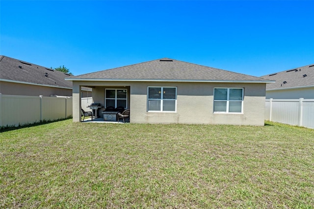 1918 Marabou Dr, Davenport, FL 33896 - rear view of house with a lawn, a fenced backyard, and stucco siding