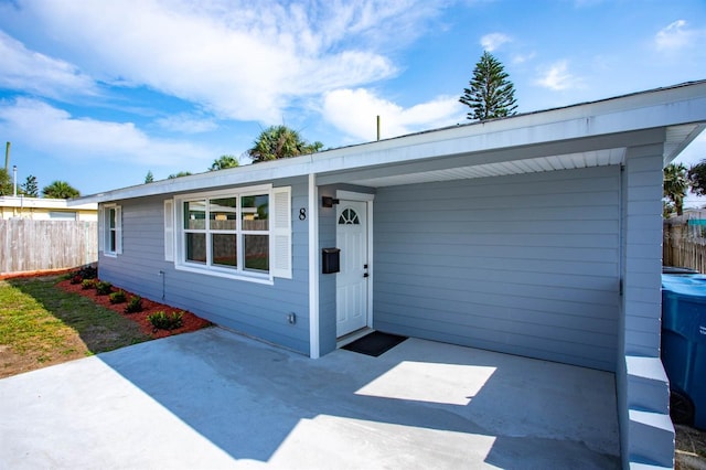 single story home with a patio area and fence