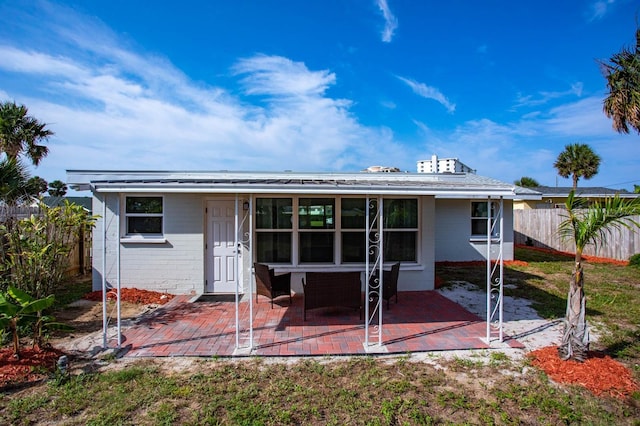 back of property featuring a patio area, concrete block siding, and fence private yard