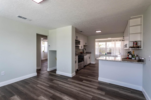 kitchen with white cabinets, open shelves, range with electric cooktop, dark wood finished floors, and stainless steel microwave