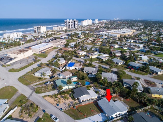 birds eye view of property with a water view and a view of city