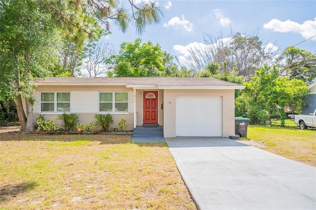 1411 N Powers Dr, Orlando, FL 32818 - ranch-style house featuring a garage, driveway, and a front lawn