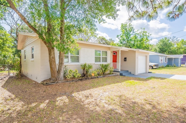 1411 N Powers Dr, Orlando, FL 32818 - ranch-style house featuring a front lawn, driveway, fence, and a garage