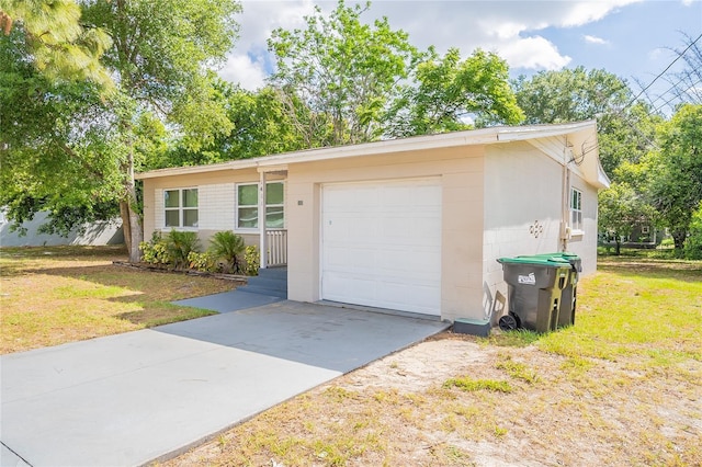 1411 N Powers Dr, Orlando, FL 32818 - view of front facade with a garage, concrete block siding, a front yard, and concrete driveway