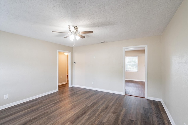 1411 N Powers Dr, Orlando, FL 32818 - spare room with dark wood finished floors, visible vents, a ceiling fan, baseboards, and a textured ceiling