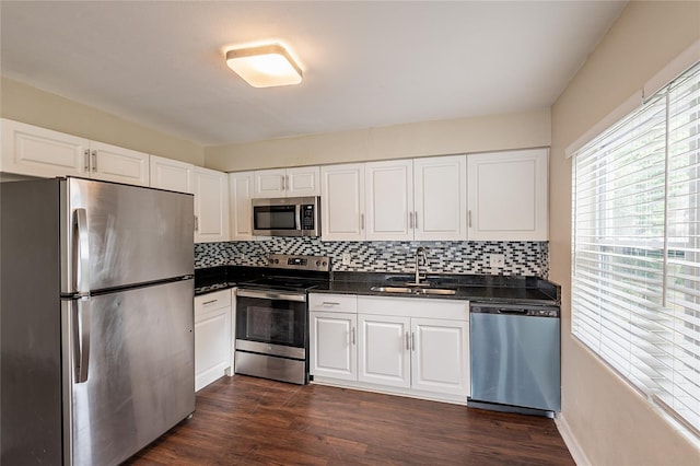 1411 N Powers Dr, Orlando, FL 32818 - kitchen featuring dark wood finished floors, tasteful backsplash, stainless steel appliances, and a sink