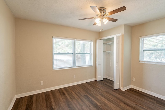1411 N Powers Dr, Orlando, FL 32818 - unfurnished bedroom featuring baseboards, dark wood-style flooring, and multiple windows