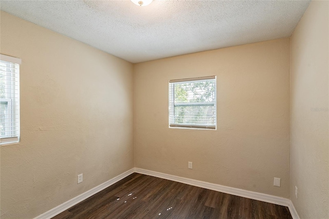 1411 N Powers Dr, Orlando, FL 32818 - spare room with dark wood-type flooring, a textured ceiling, and baseboards
