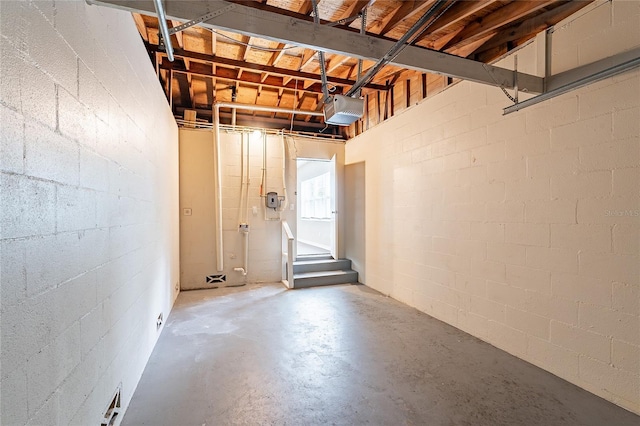 1411 N Powers Dr, Orlando, FL 32818 - basement with concrete block wall, stairs, and a garage