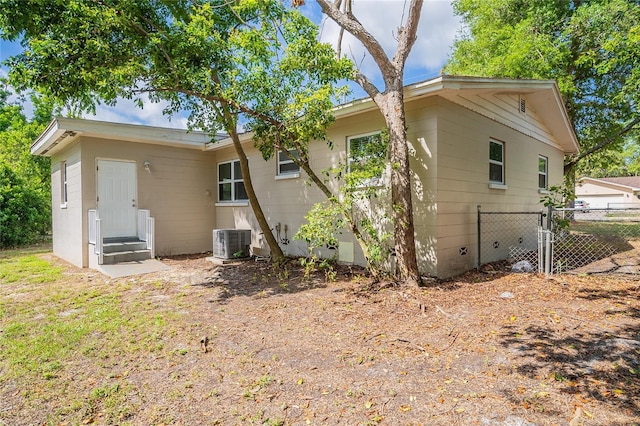 1411 N Powers Dr, Orlando, FL 32818 - rear view of house with fence and central air condition unit