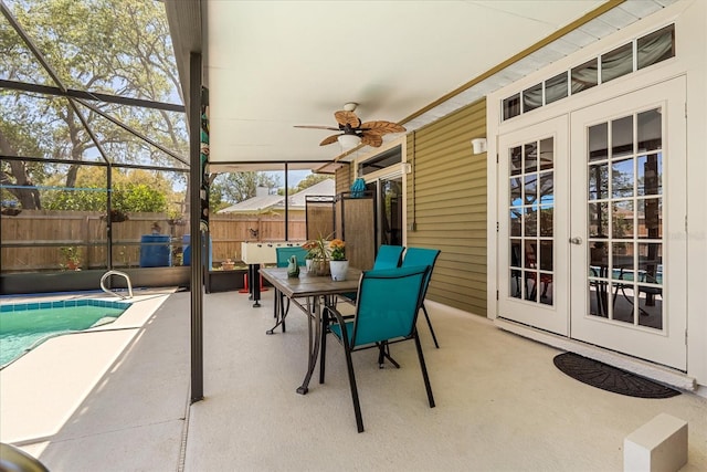 view of patio / terrace featuring french doors, outdoor dining area, fence, a fenced in pool, and ceiling fan