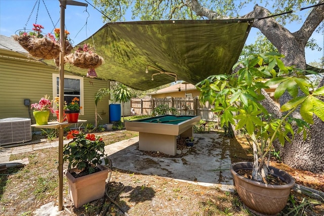exterior space with central air condition unit and fence