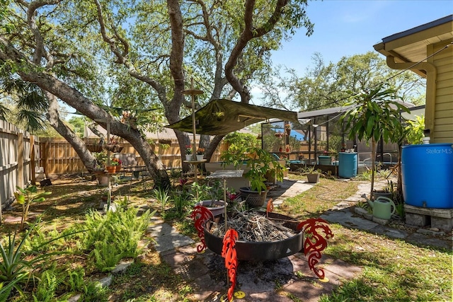 view of yard with a lanai and a fenced backyard