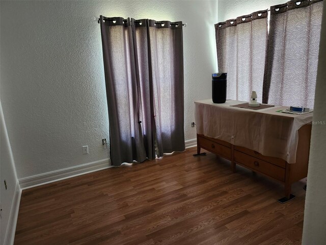 4666 Clarke St, North Port, FL 34286 - office area featuring a textured wall, wood finished floors, and baseboards
