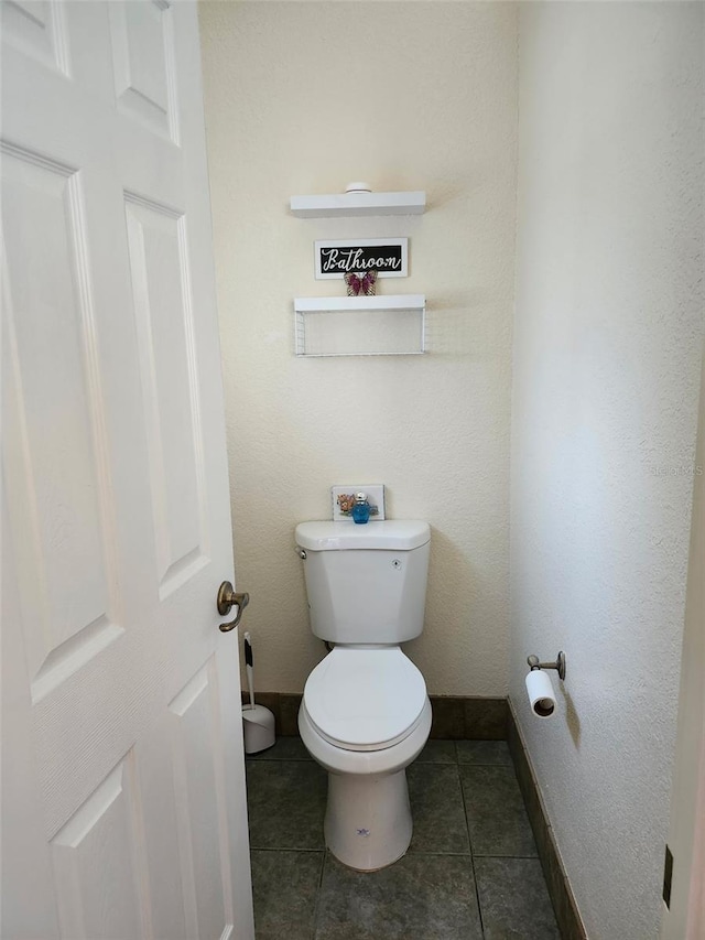 4666 Clarke St, North Port, FL 34286 - bathroom with toilet, baseboards, and tile patterned flooring
