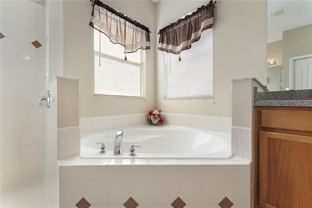 full bath featuring a bath, vanity, a healthy amount of sunlight, visible vents, and tiled shower
