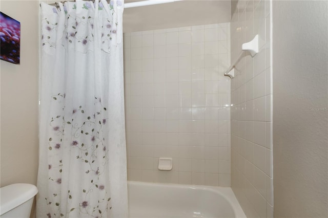 bathroom with toilet and shower / bath combo with shower curtain