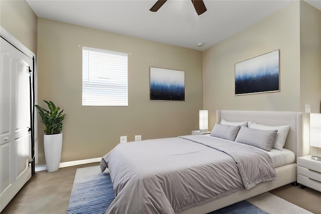 carpeted bedroom featuring baseboards and ceiling fan