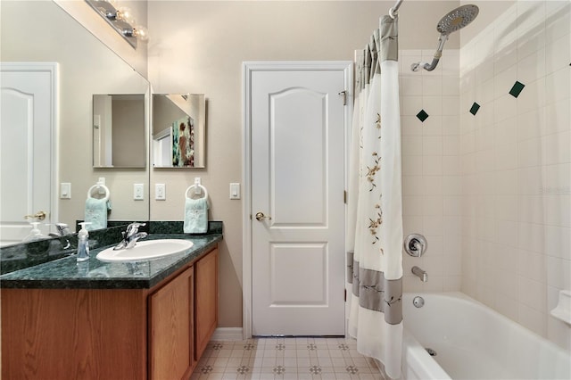 full bath featuring shower / bath combination with curtain, baseboards, vanity, and tile patterned floors
