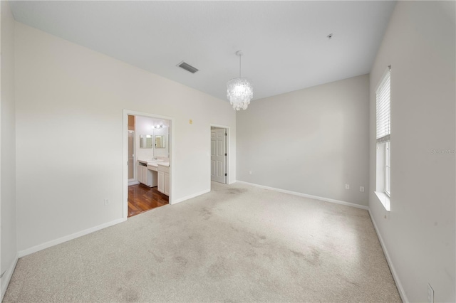 carpeted spare room featuring baseboards, visible vents, a chandelier, and a healthy amount of sunlight