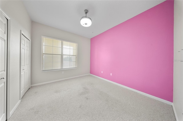 unfurnished bedroom featuring carpet and baseboards