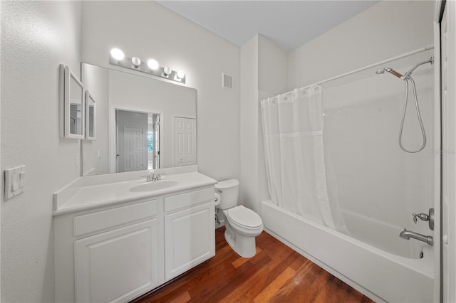 bathroom featuring shower / bath combo, toilet, visible vents, wood finished floors, and vanity