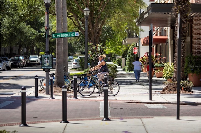 view of street with curbs, sidewalks, and street lights