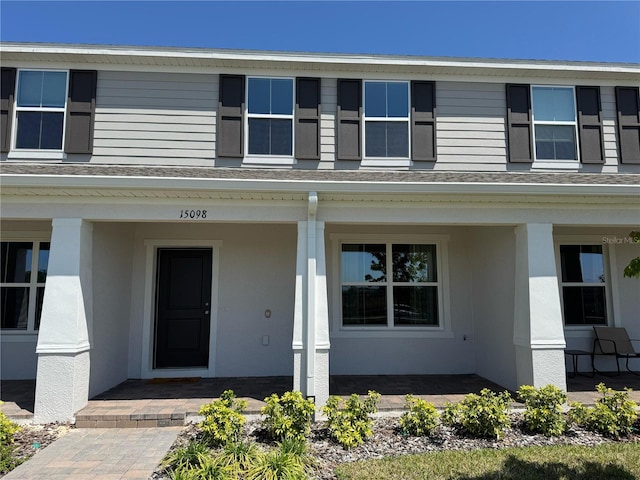 view of front of home featuring stucco siding and covered porch