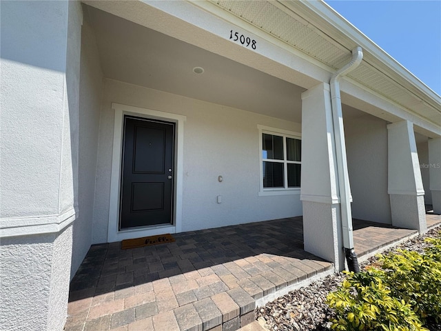 view of exterior entry with stucco siding