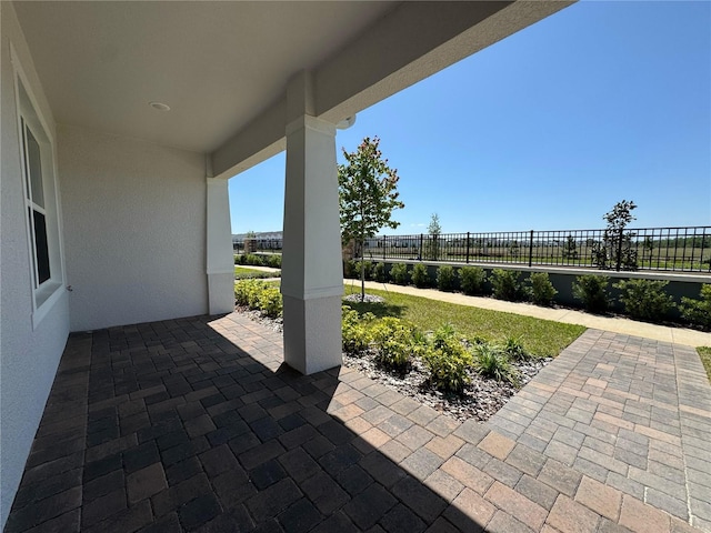 view of patio / terrace featuring fence