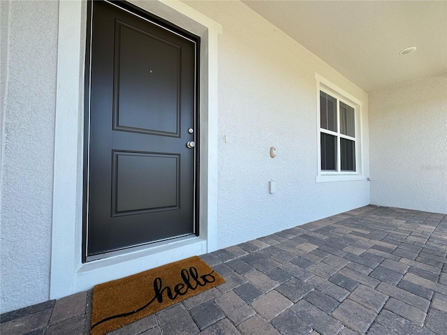 doorway to property with stucco siding