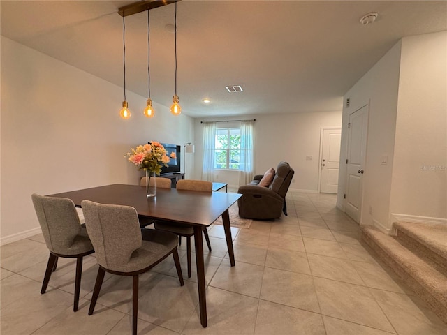 dining room with light tile patterned floors, baseboards, and visible vents