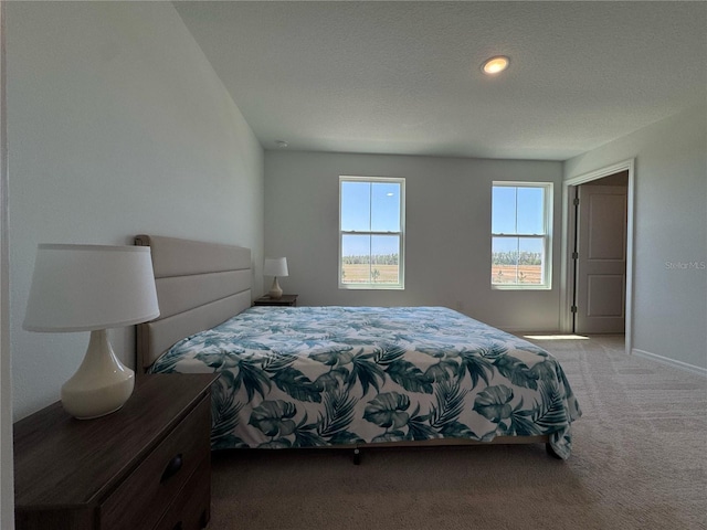 carpeted bedroom featuring baseboards